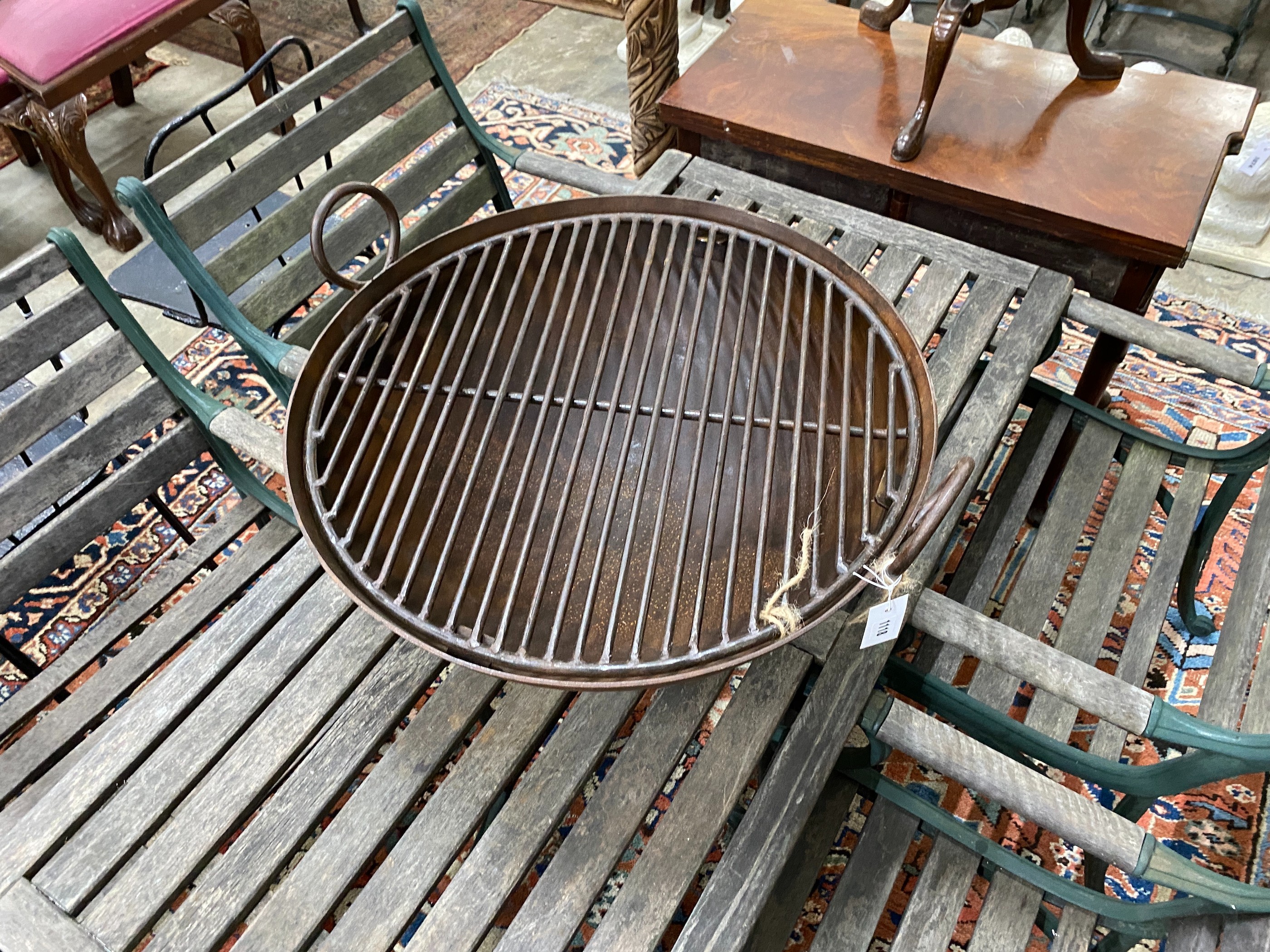 A cast and wrought iron circular fire pit on low stand, diameter 62cm, height 29cm